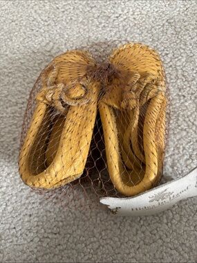 Hides in Hand. Tan baby Moccasins